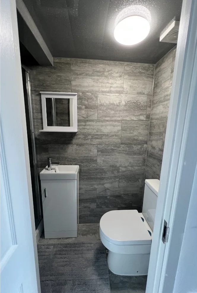 Finished bathroom with basin unit, WC and shower