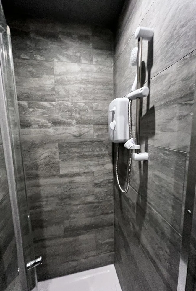 Electric shower and full-height wall tiling
