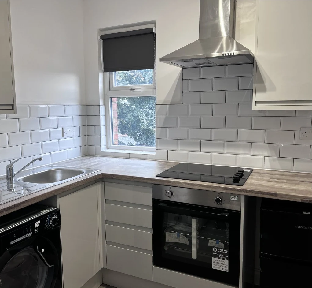 Completed communal kitchen with oven, hob, sink and extractor